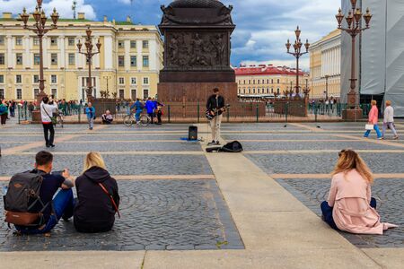 St. Petersburg, Russia - June 26, 2019: People listen to the music of local street musician on the...
