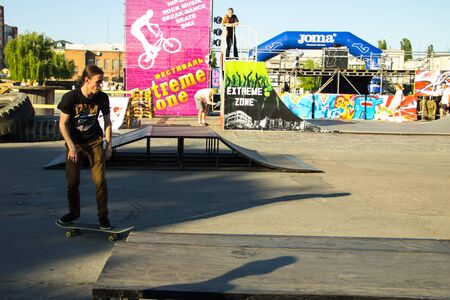 Kremenchug, Ukraine - June 5, 2017: Skateboarder doing a trick in a skate park on youth festival Extreme zoneのeditorial素材