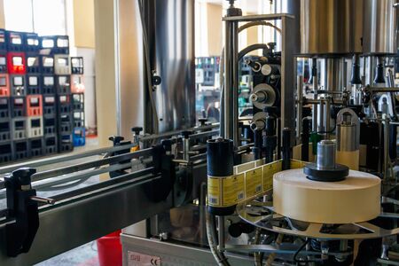 Tbilisi, Georgia - May 1, 2018: Automatic labeling machine equipment at Bagrationi factory of...