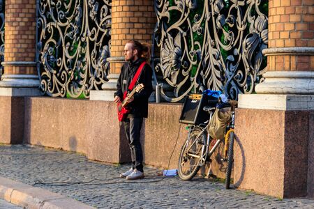 St. Petersburg, Russia - June 24, 2019: Local street musician plays guitar near Church of the Saviour on Spilled Blood in Saint Petersburg, Russiaのeditorial素材