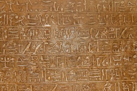 Ancient egyptian hieroglyphs carved on the stone wallの写真素材
