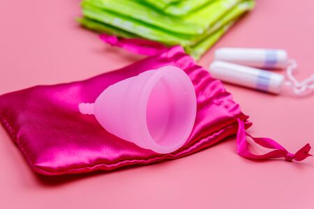 Sanitary pad, tampons and menstrual cup on pink background. Concept of critical days, menstruation, feminine hygieneの写真素材