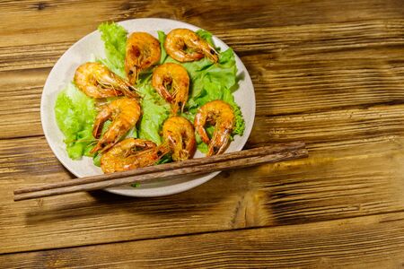 Tasty baked shrimps on a wooden tableの写真素材