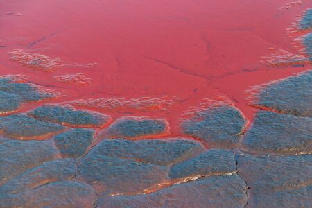 Close-up of red water polluted with iron ore wasteの写真素材
