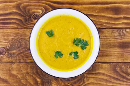 Pumpkin soup on a wooden table. Top viewの写真素材