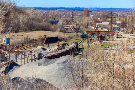 Loading breakstone into freight train in a granite quarryの写真素材