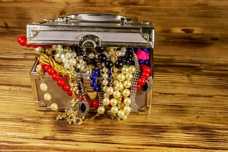 Jewelry box full of jewelry and accessories on wooden backgroundの写真素材