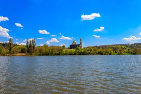 View of the beautiful lake and old orthodox church on a shore