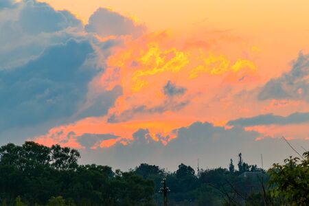 Orange sunset over a meadow at springの写真素材