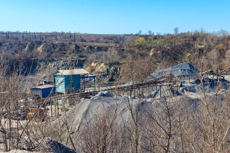 Rock crusher machine, crushing machinery, conveying crushed granite gravel stone in a granite...