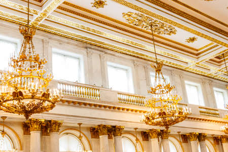 St. Petersburg, Russia - June 26, 2019: Vintage classical chandeliers hanging under a ceiling in the St. George Hall of Winter palace (State Hermitage Museum) in St. Petersburg, Russiaのeditorial素材