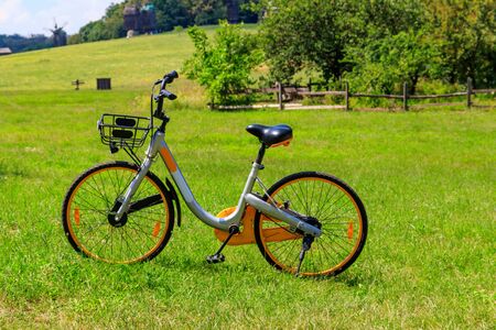 Modern bicycle parked on a green lawn in rural areaの写真素材