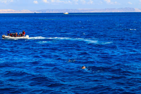 Hurghada, Egypt - December 7, 2018: Inflatable boat with tourists near coral reef in Red sea, Egypt