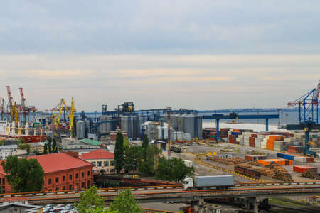 Hoisting cranes, transport containers and granaries at cargo sea port in Odessa, Ukraine