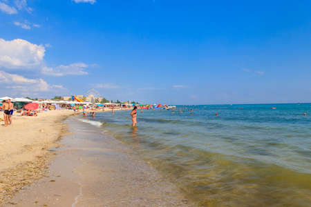 Lazurne, Ukraine - July 18, 2020: Unknown people on the beach of the Black sea in Lazurne, Ukraine