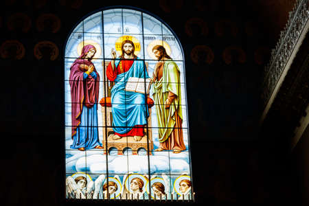 Stained glass window depicting Jesus, Virgin Mary and St. John the Baptistのeditorial素材
