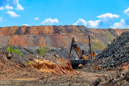 Big excavator working in iron ore quarry. Mining industryの写真素材