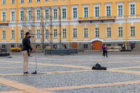 St. Petersburg, Russia - June 26, 2019: Local street musician plays guitar on the Palace Square in...