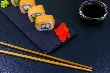 Sushi rolls Philadelphia on a black slateの写真素材