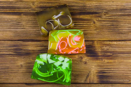 Set of handmade soap bars on wooden background. Top view