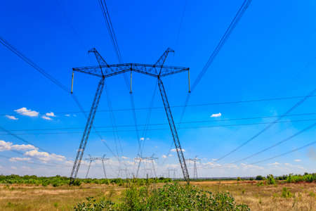 High voltage power line against blue skyの写真素材