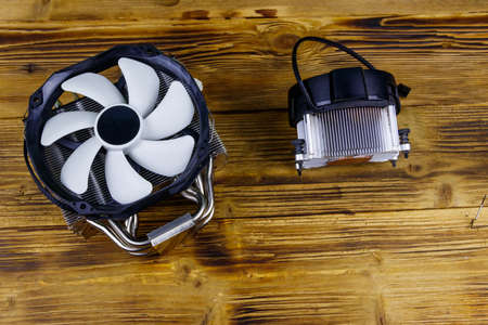 Two modern CPU coolers on a wooden desk. Top viewの写真素材