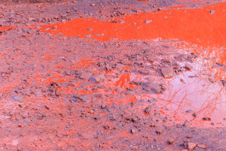 Close-up of red water polluted with iron ore waste