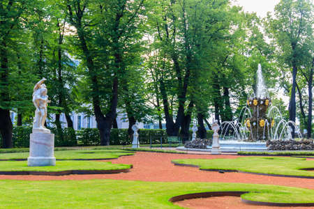 Fountain Crown and marble statues in old city park "Summer garden" in St. Petersburg, Russiaの写真素材