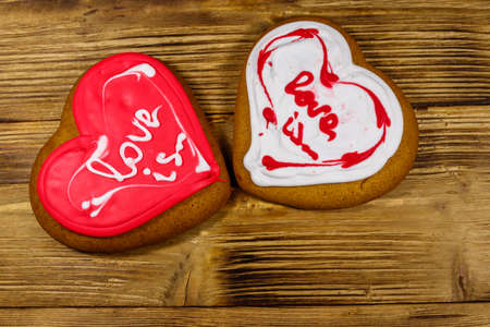 Heart shaped gingerbread cookies on wooden table. Top view. Dessert for valentine dayの写真素材