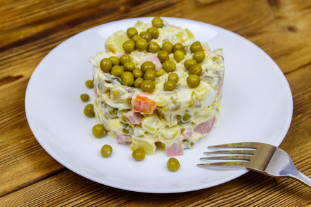 Traditional Russian festive salad Olivier on wooden tableの写真素材
