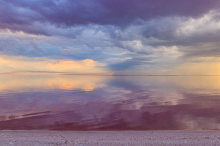 Dark storm clouds over a salt lake before a rainの写真素材