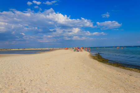 Lazurne, Ukraine - July 18, 2020: Tourists on a sandy beach of Dzharylhach island near Lazurne, Ukraineのeditorial素材