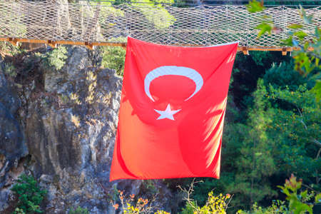 Turkish flag hanging from suspension wooden bridge in Goynuk canyon in Antalya province, Turkey