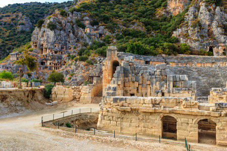 Ruins of ancient Greek-Roman theater and rock-cut tombs of Lycian necropolis of the ancient city of Myra in Demre, Antalya province in Turkeyの写真素材