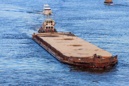 Heavy long barge sailing on the Dnieper river in Kiev, Ukraineの写真素材