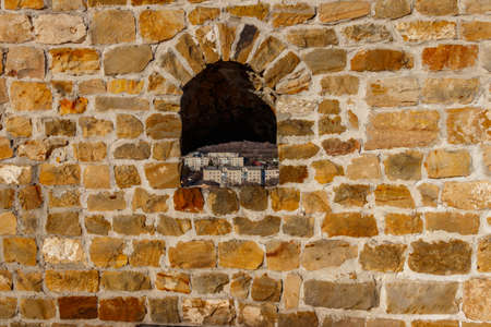 Background of the old stone wall with a loophole