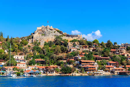 View of ancient Lycian town Simena with fortress on a mount on the coast of the Mediterranean sea in Antalya Province, Turkeyのeditorial素材
