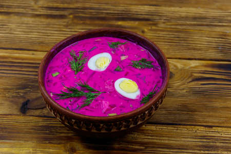 Cold beetroot soup on a wooden table