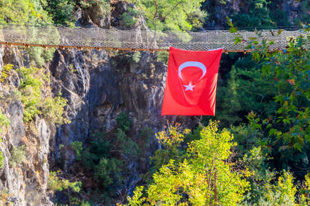 Turkish flag hanging from suspension wooden bridge in Goynuk canyon in Antalya province, Turkeyの写真素材