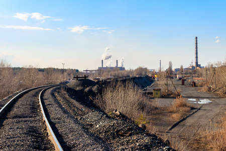 Railway tracks in the industrial zone with factoriesの写真素材