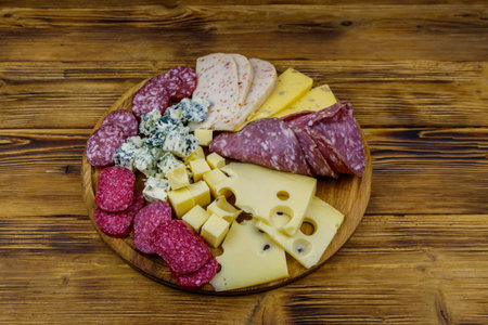Antipasti platter with assortment of italian salami and cheese on wooden tableの写真素材