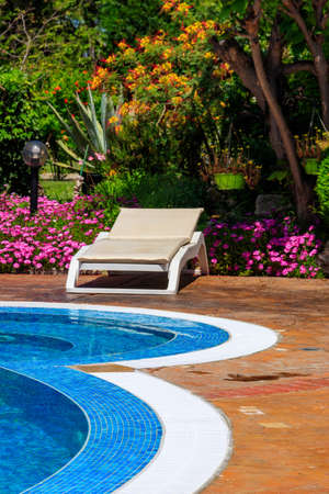 Chaise longue near a swimming pool. Concept of spa, rest, relaxation, holidays, resortの写真素材