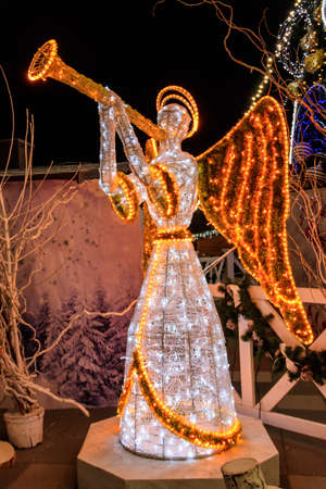 Illuminated Angel. Christmas decoration in city parkの写真素材