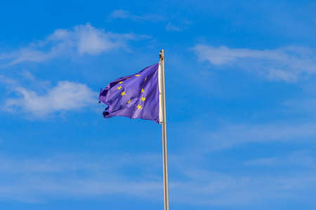 Waving flag of European Union against blue skyの写真素材