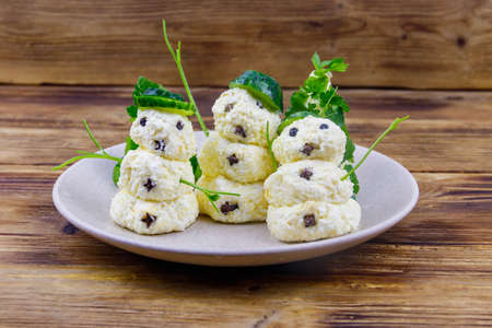 Christmas salad in the shape of snowmen and Christmas tree on a plate on wooden tableの写真素材