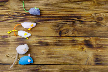 Set of mouses toys for cat on wooden background. Top view, copy spaceの写真素材