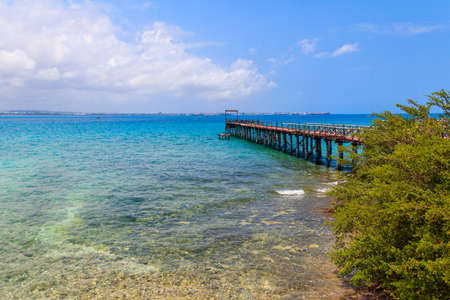 Wooden pier leading to clear blue ocean on Prison island, Zanzibar, Tanzaniaの写真素材