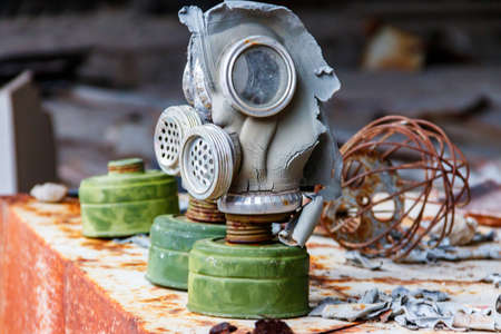 Old abandoned soviet gas masks used during the liquidation of the effects of Chernobyl disaster in...