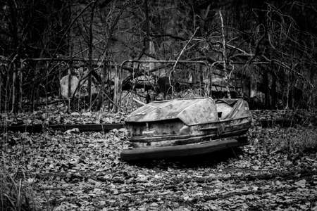 Abandoned bumper cars in the amusement park of Pripyat city in Chernobyl Exclusion Zone, Ukraine. Black and white toneの写真素材