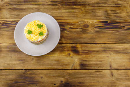 Traditional russian salad Mimosa on wooden table. Top viewの写真素材